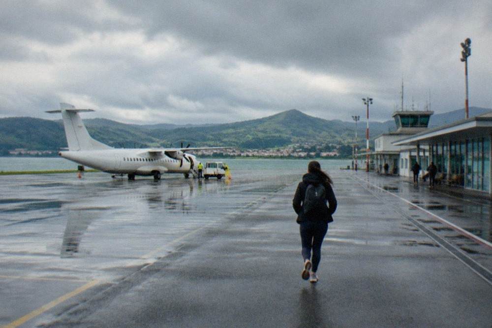A small regional airport terminal building under a cloudy sky in northern Spain