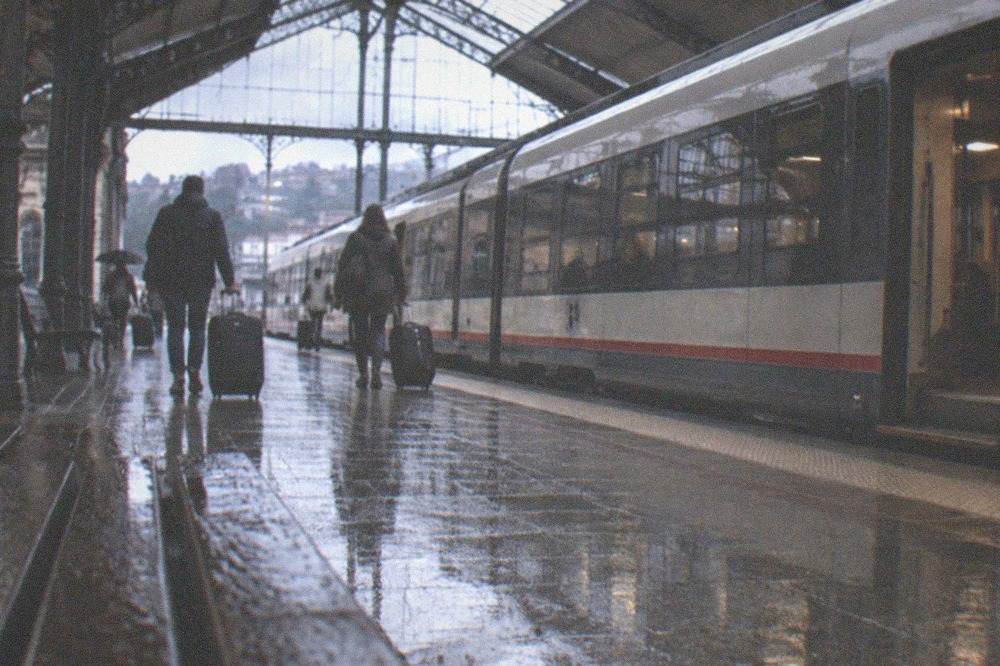 A regional train at a platform in a northern Spanish station in the rain
