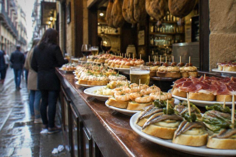 Narrow Old Town street in the Parte Vieja with bar fronts and pintxo counters