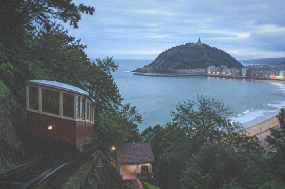 Ondarreta beach with Monte Igueldo and its funicular tower rising at the far end