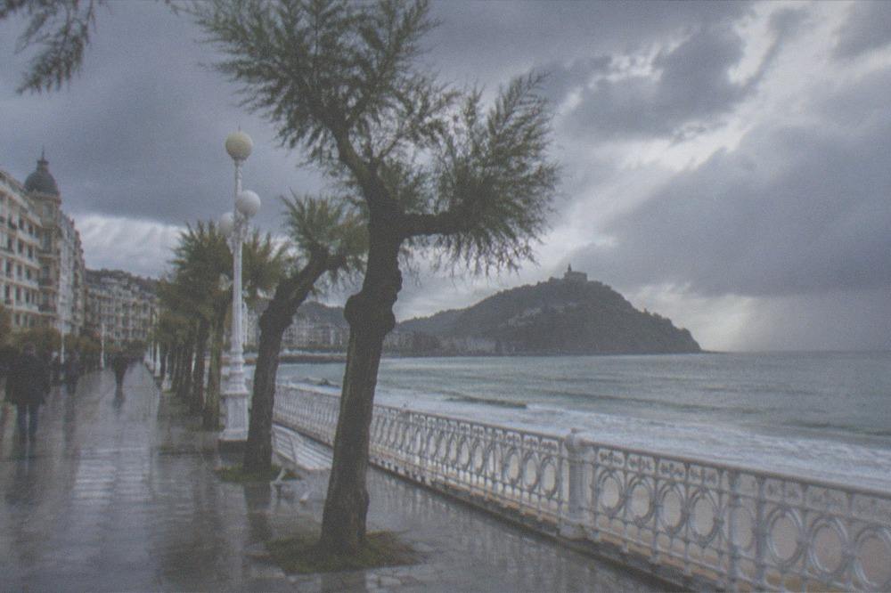 The La Concha promenade under cloud with rain sweeping across the bay