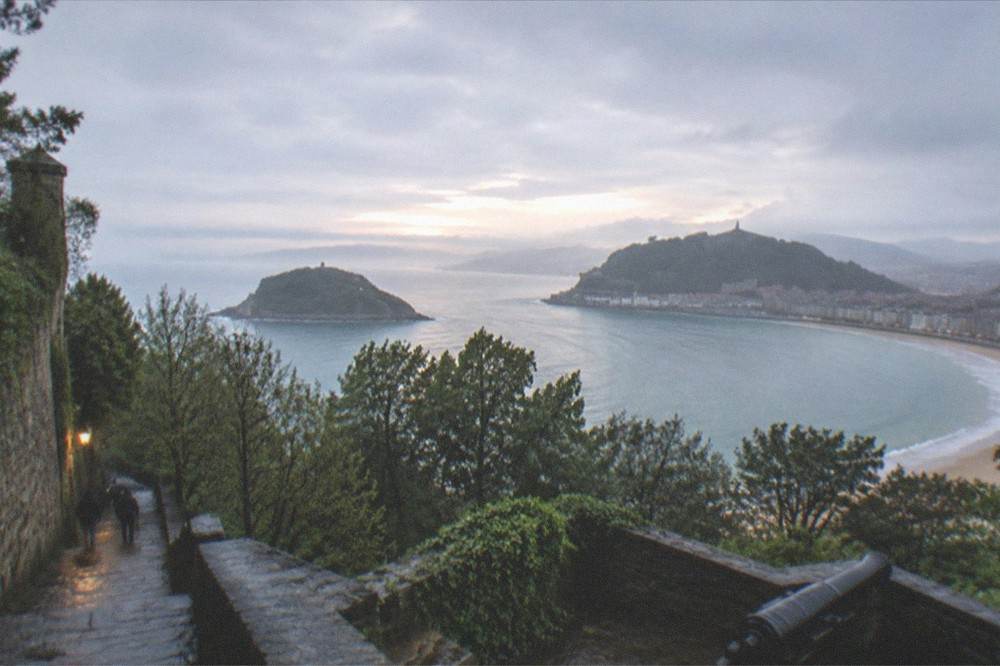 Evening light over La Concha bay with Santa Clara island and the Urgull hill