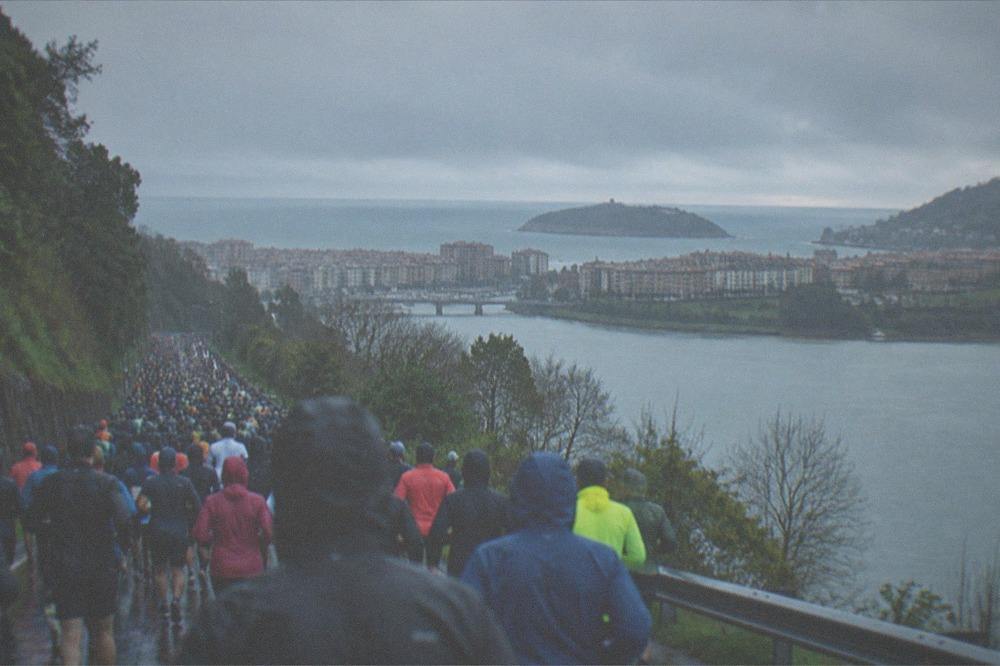 A hilltop viewpoint above a city skyline with a bay and an island beyond