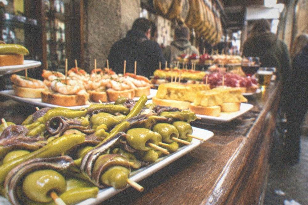 A close-up of gilda skewers with anchovy, pepper and olive on a bar counter