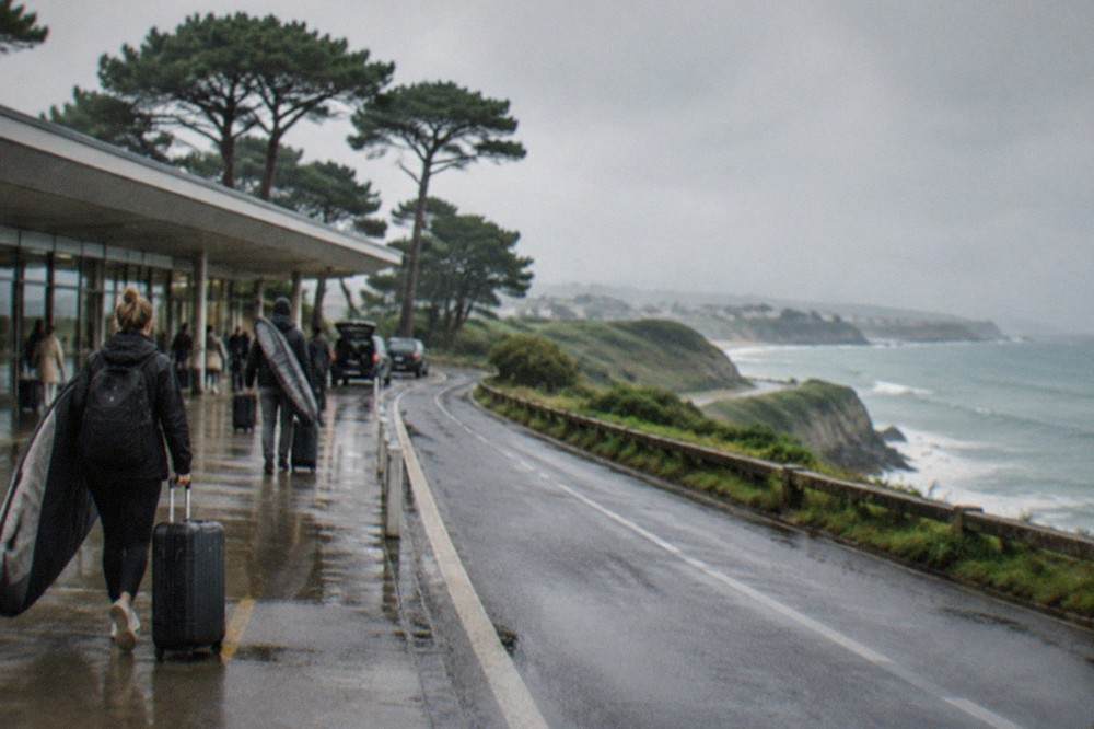 A coastal road winding along green cliffs with the sea on one side