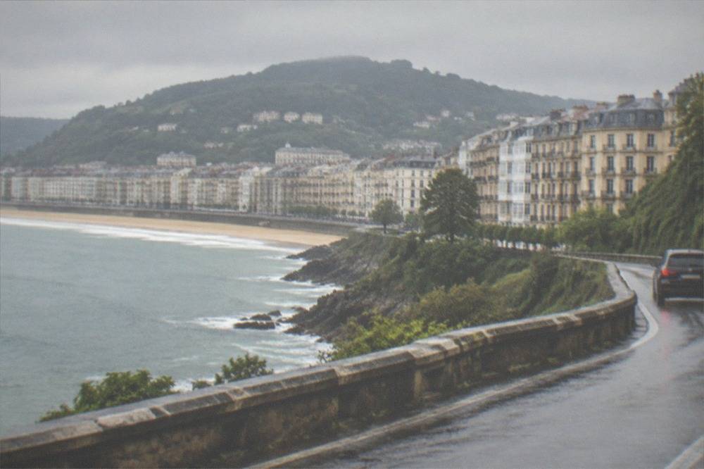 A coastal motorway winding along green cliffs above the Bay of Biscay