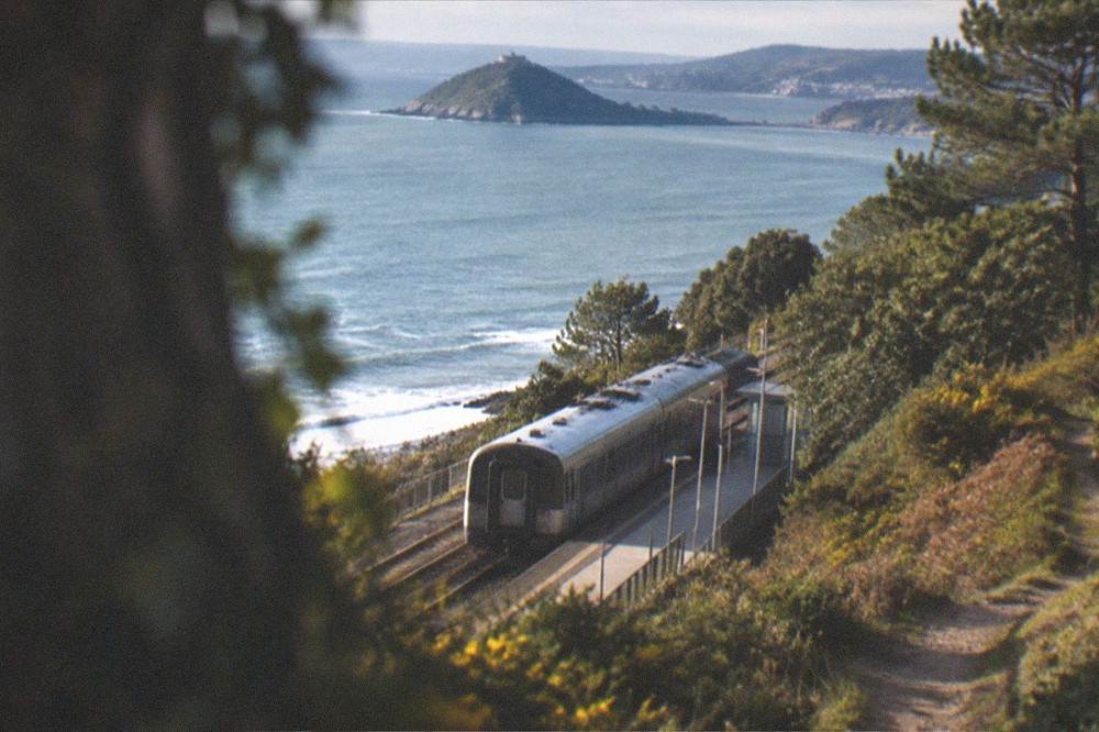 Single carriage train at a small coastal station platform
