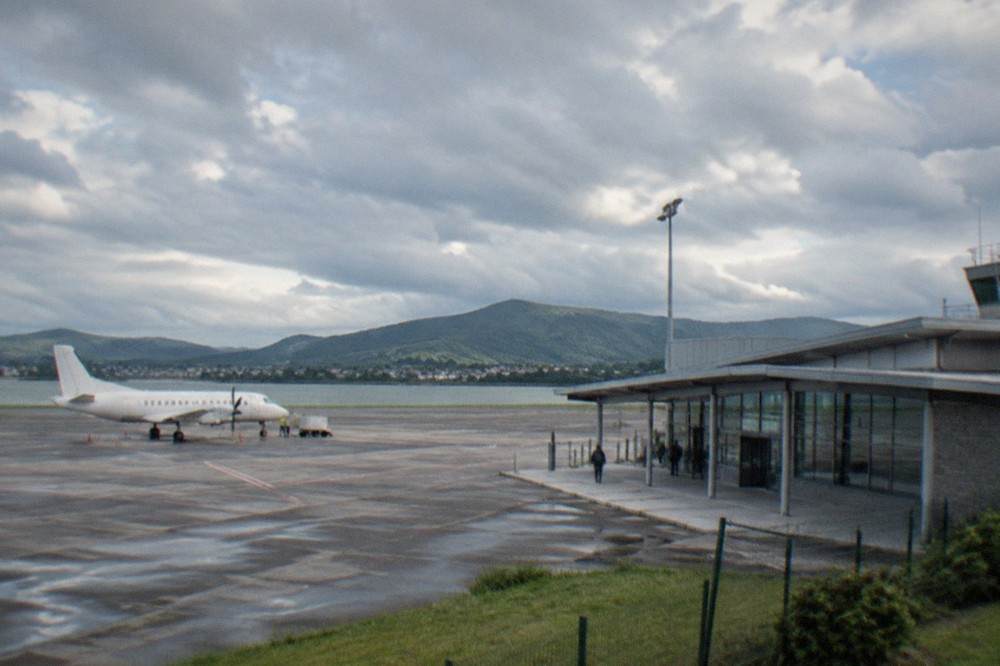 A small regional airport terminal building under a cloudy sky in the Basque Country