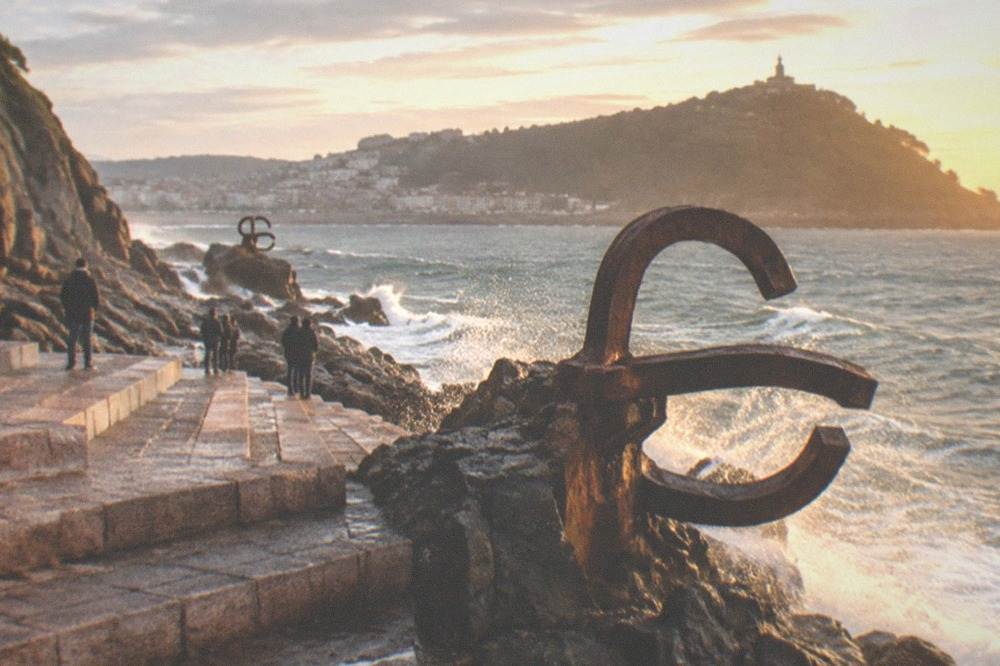 The Peine del Viento steel sculptures on the rocks at the west end of the bay