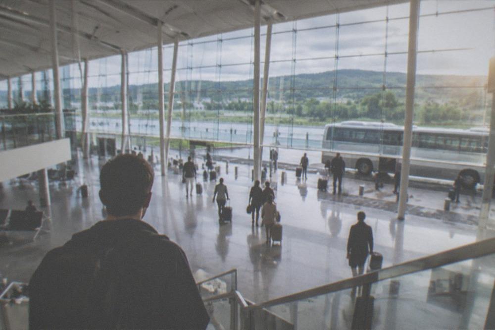 Traveler with a backpack looking at a departure board in a European train station