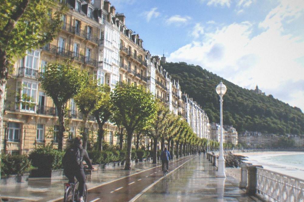 Cyclists riding along a dedicated bike lane on the San Sebastián seafront