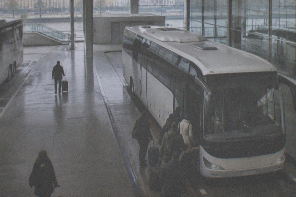 A regional coach parked at the San Sebastián bus station with passengers boarding