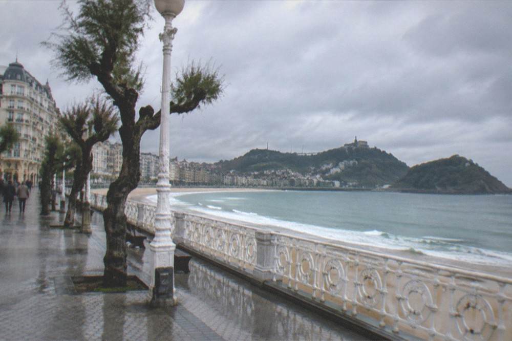 Rain clouds over La Concha bay with the seafront promenade below