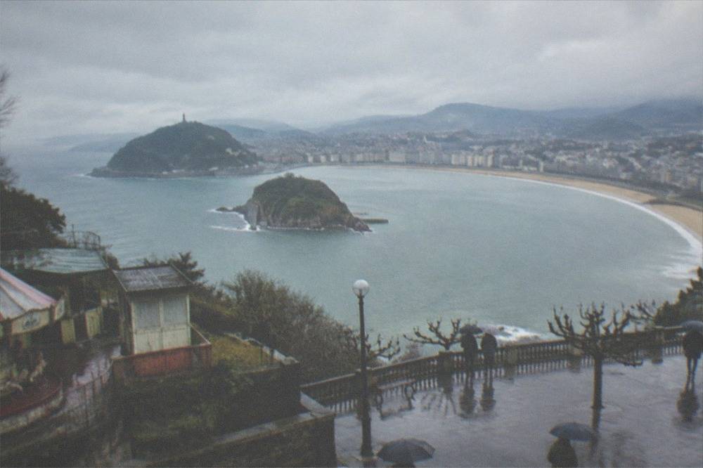 Empty winter promenade at La Concha with grey sea and the Monte Igueldo headland in the distance
