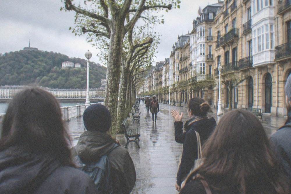 A guide speaking to a small group on a walking tour in the Old Town of San Sebastián