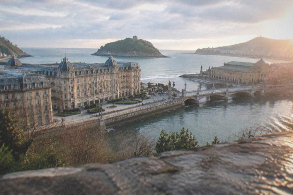 Hilltop viewpoint over a bay with a small island and city rooftops