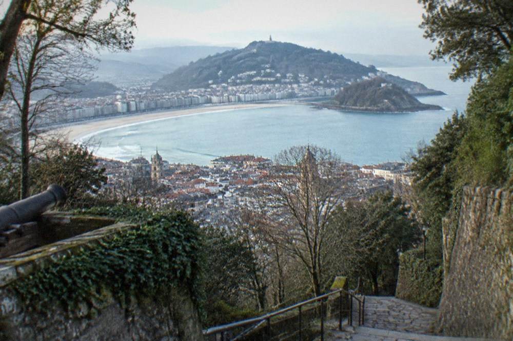 View from Monte Urgull over the Old Town rooftops and La Concha bay toward Monte Igueldo