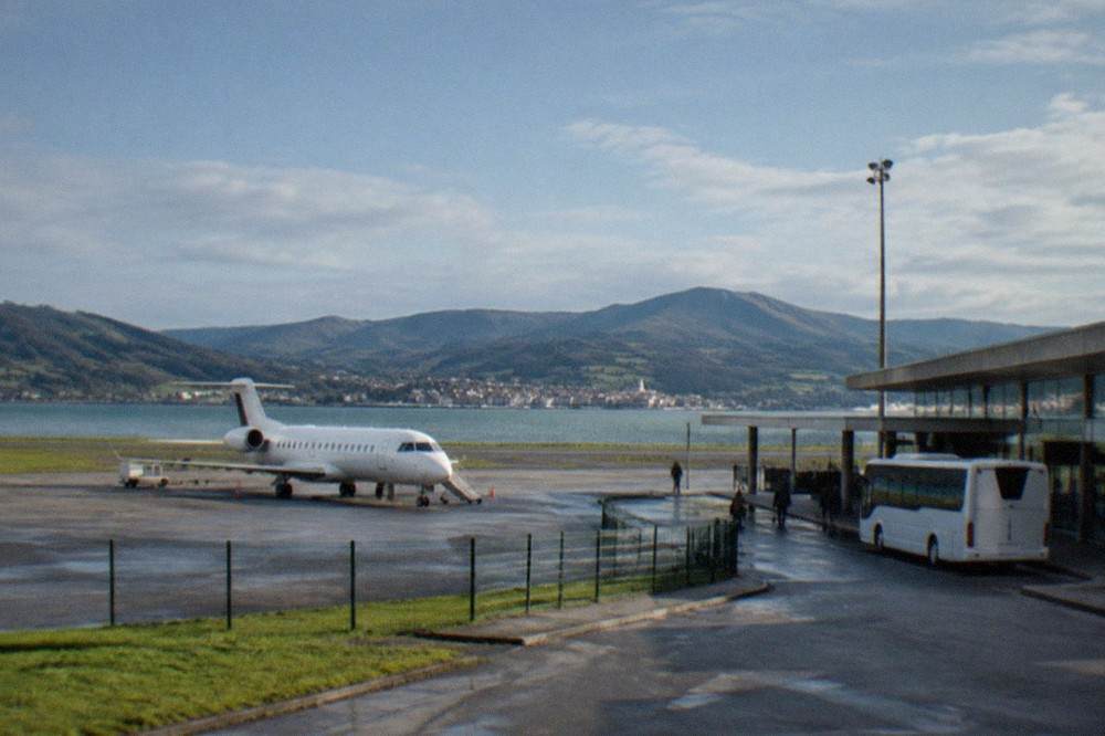 A bus waiting at a small regional airport terminal in the Basque Country
