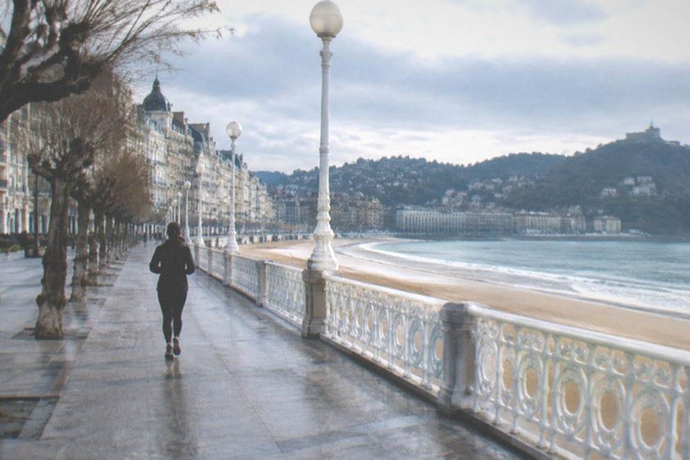 Empty La Concha beach promenade in San Sebastián on a calm overcast morning