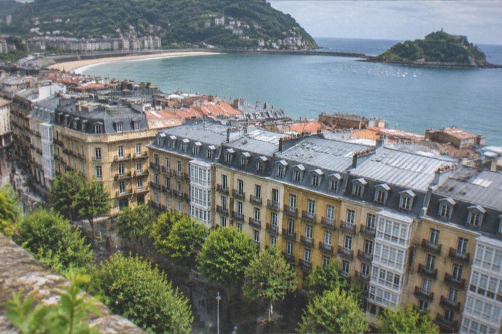 View across the rooftops of the Old Town toward La Concha bay from Monte Urgull