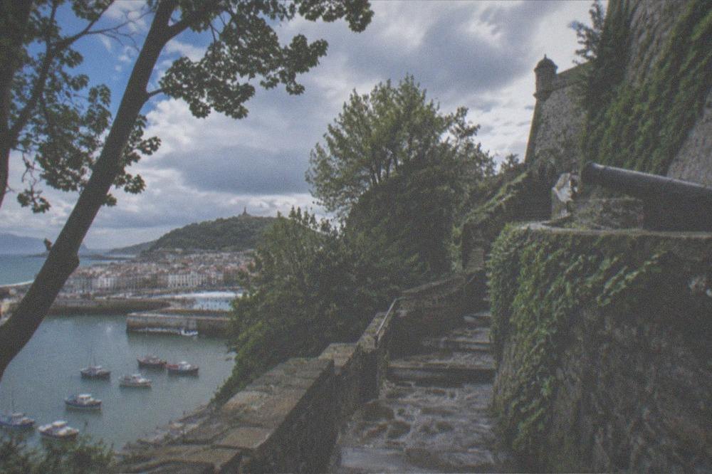 Traditional fishing boats moored in the small harbour at the foot of Monte Urgull