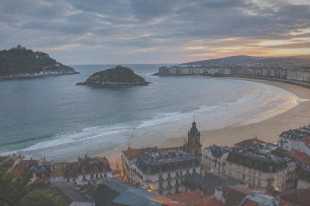 Evening light over the Parte Vieja rooftops with La Concha bay in the background
