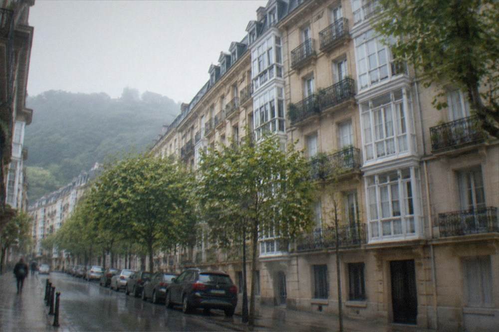 A quiet residential street in San Sebastián with a Basque language school sign on a building