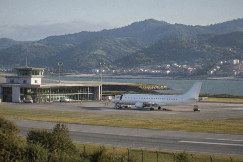 A small regional airport terminal beside an estuary on the Basque coast