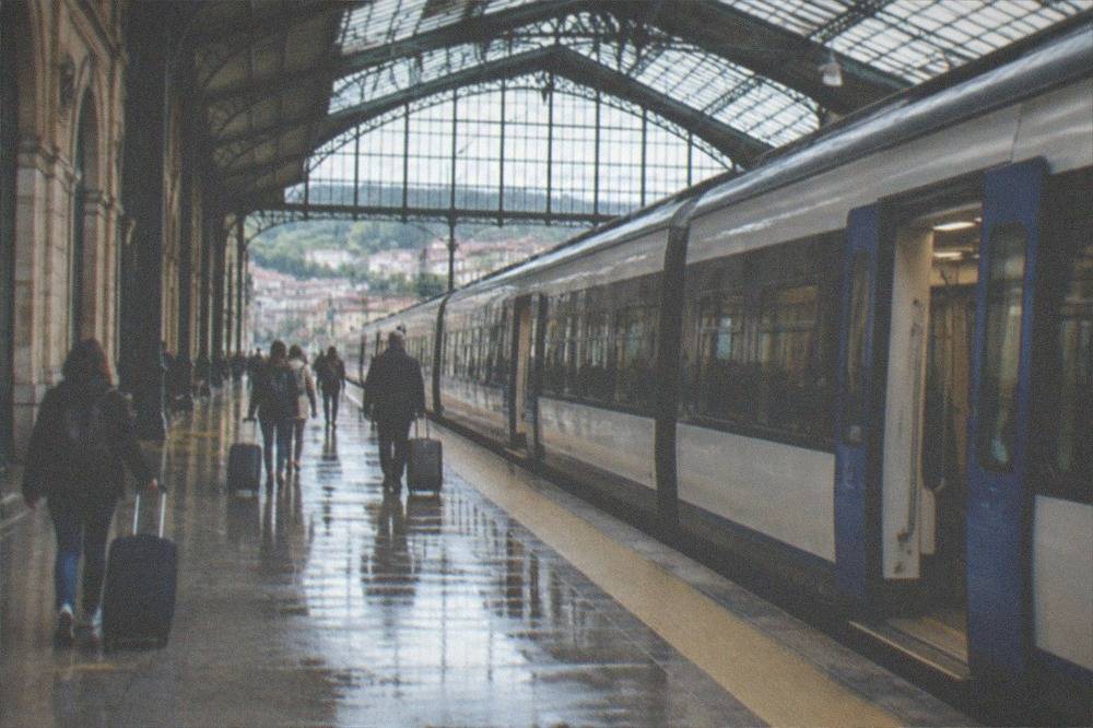 A modern suburban train at a station platform in the Basque Country