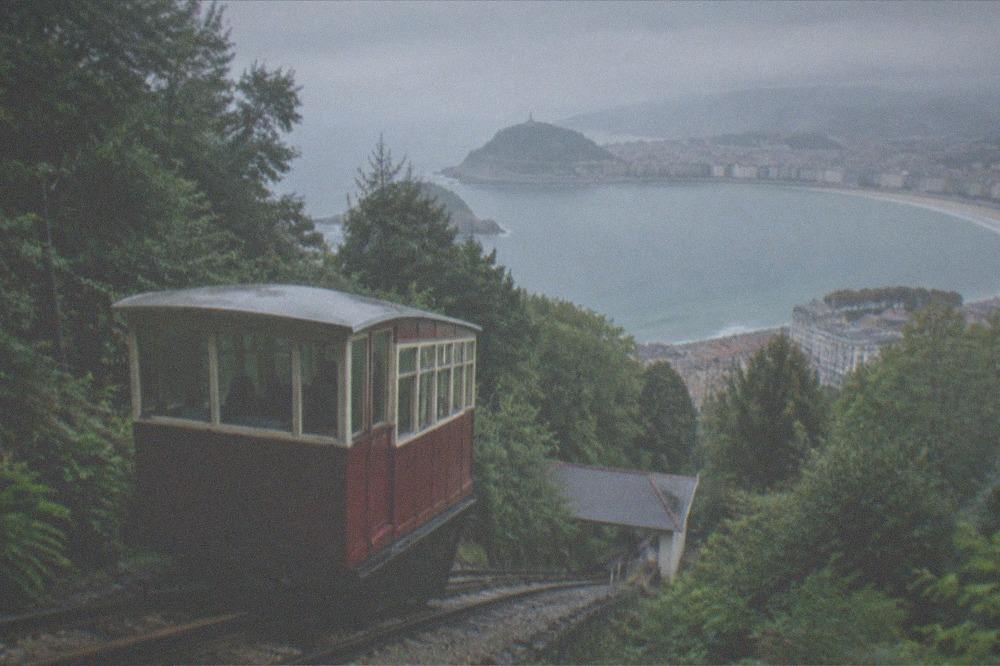 The wooden funicular car climbing Monte Igueldo with La Concha bay below