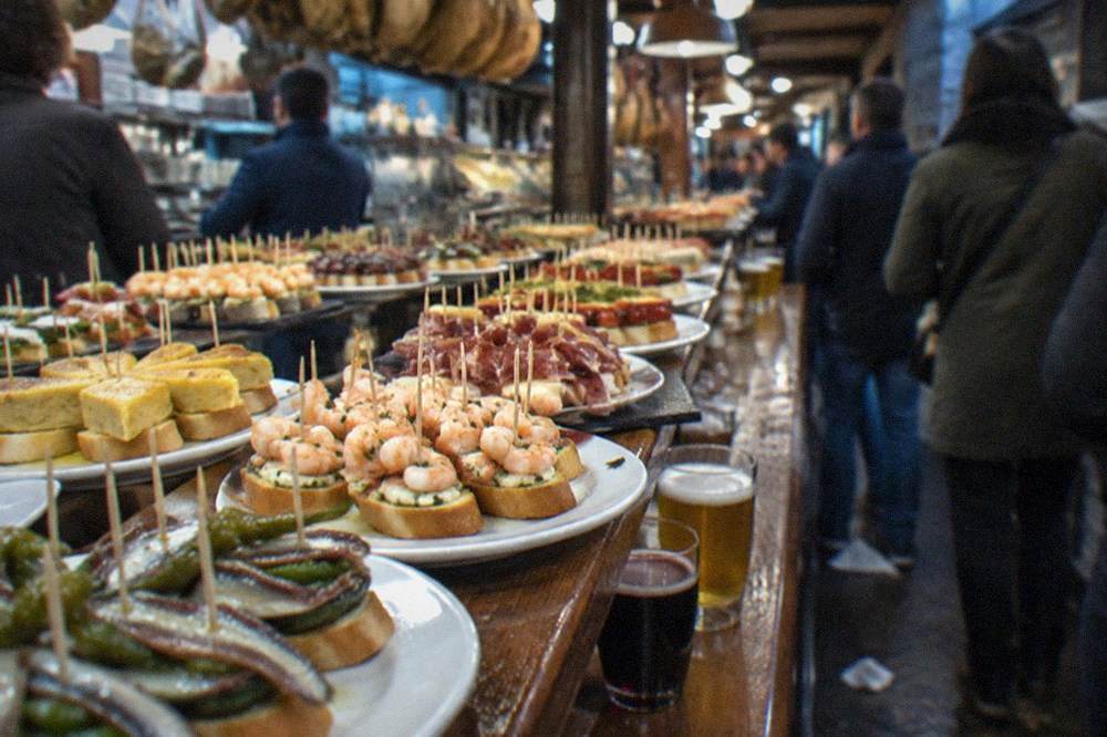 Pintxo bars in the Old Town with counters of small skewered dishes