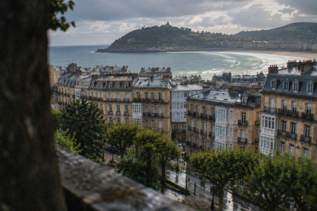 Evening view over the rooftops and bay of San Sebastián from a hillside above the city