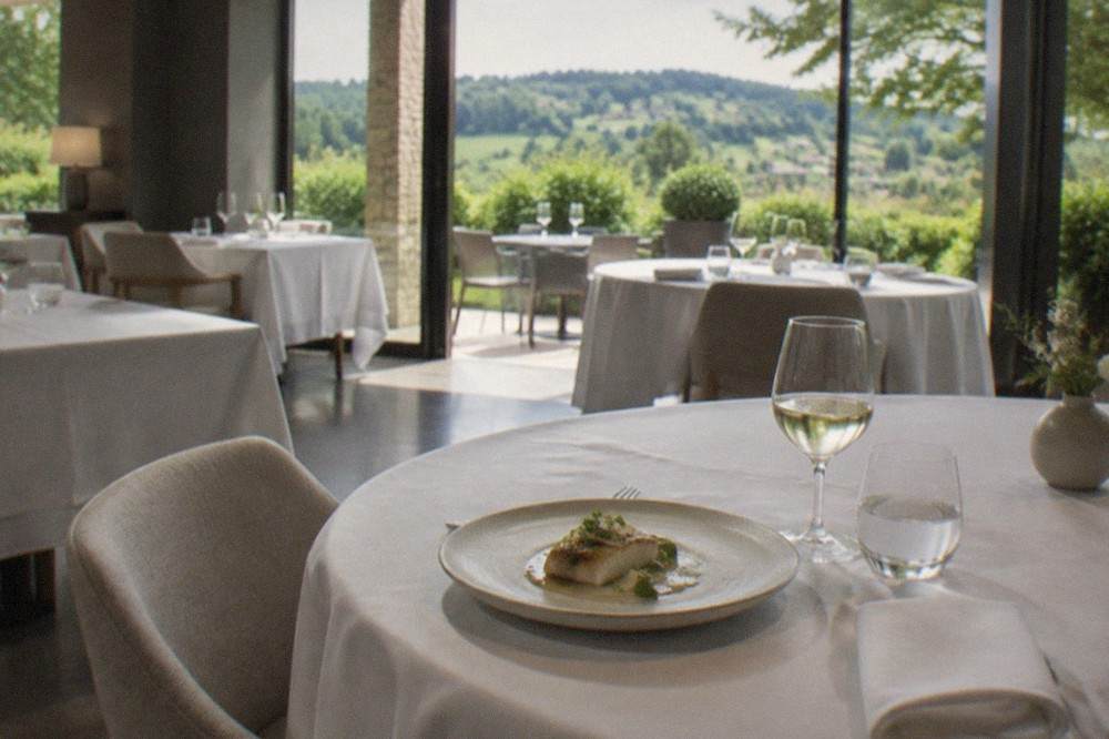 A formal dining room with set tables, glassware and linen in a Basque restaurant