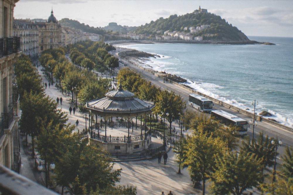 A coastal road winding above the sea toward a small Basque fishing town