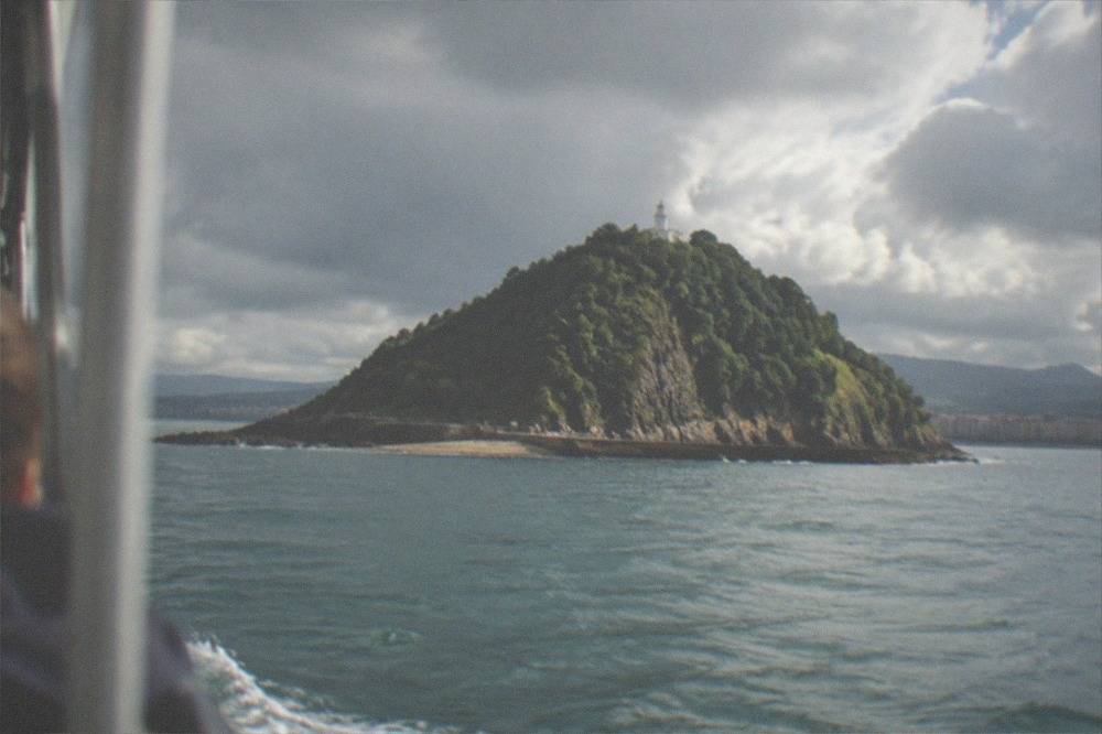 Rain clouds over La Concha bay and Santa Clara island in San Sebastián