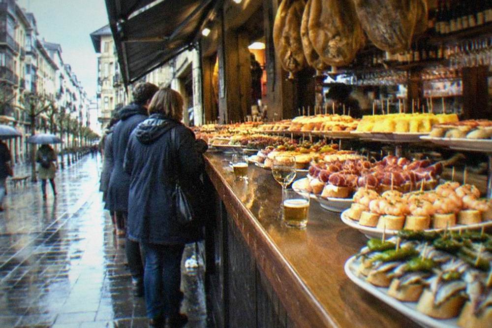 A quiet winter street in the Old Town with pintxo bar awnings and few pedestrians