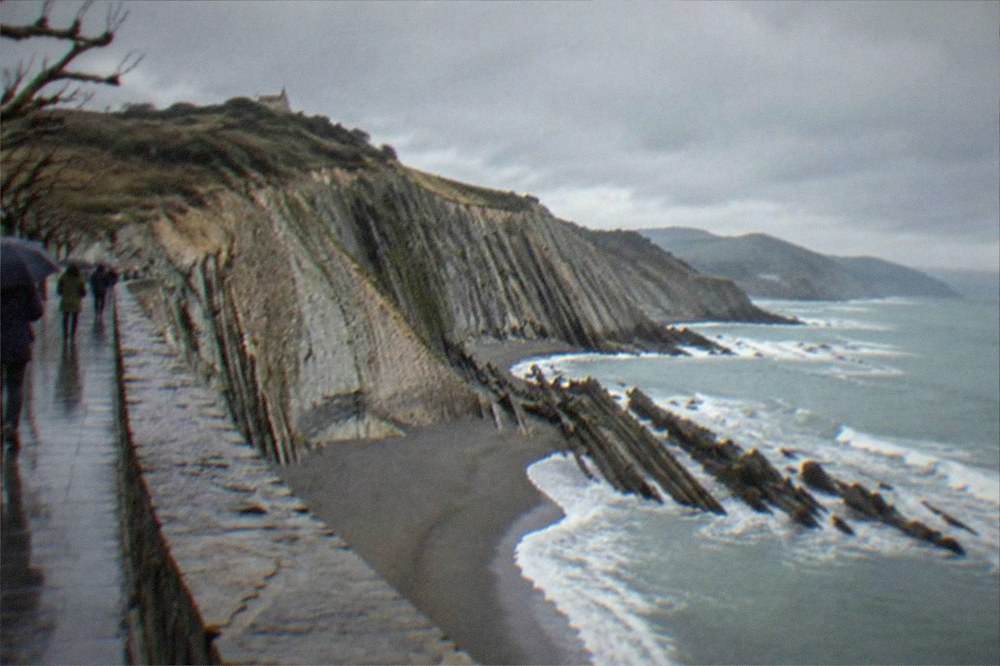 The flysch cliffs at Zumaia under a wide winter sky with the sea below