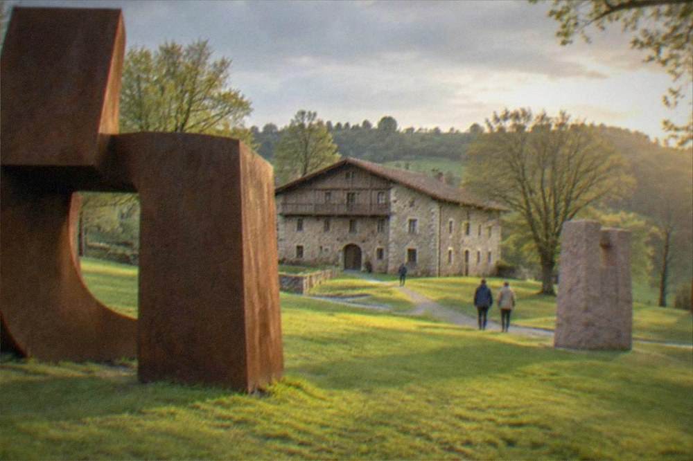 Large abstract steel sculptures standing in green woods at Chillida Leku