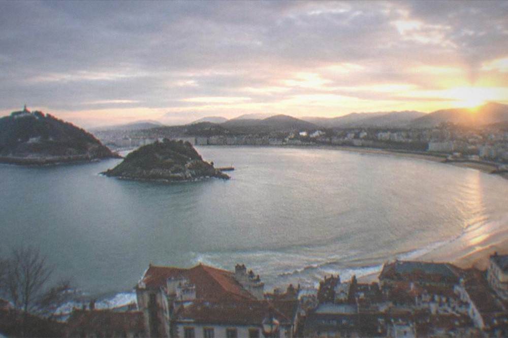 Evening light over the Parte Vieja old town rooftops and La Concha bay
