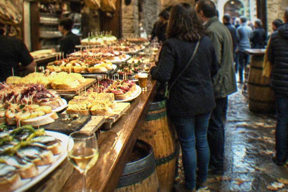 Pintxo bars in the Parte Vieja old quarter of San Sebastián with barrels, counter tops and hanging txuleta steaks