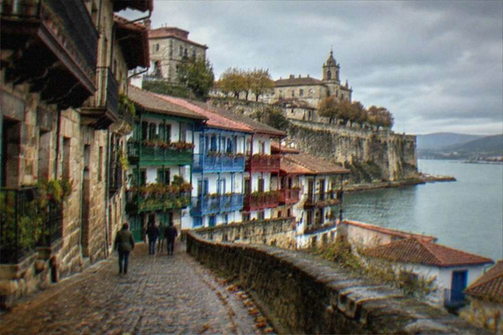 The walled old town of Hondarribia near San Sebastián with stone houses under a cloudy sky
