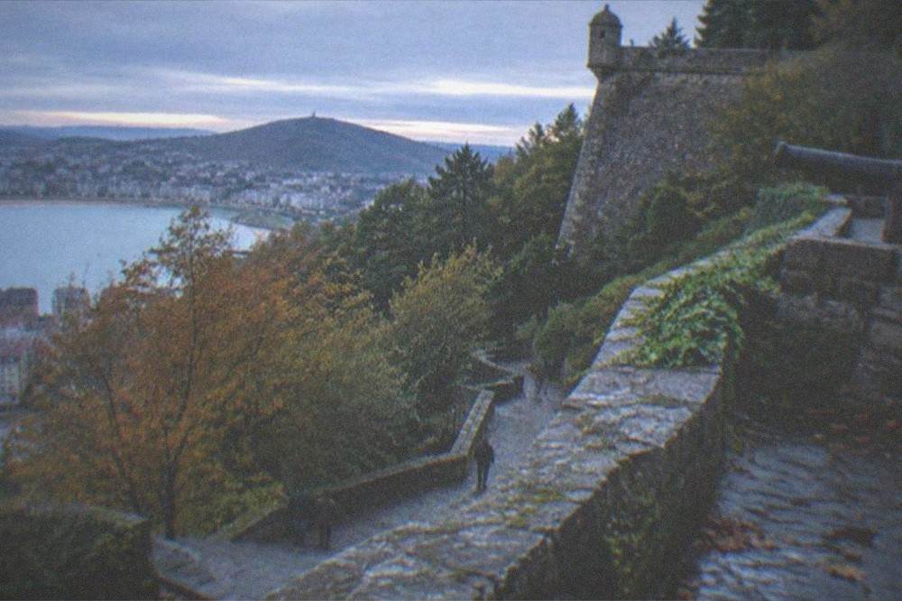Monte Urgull seen from the city with autumn trees below the castle walls