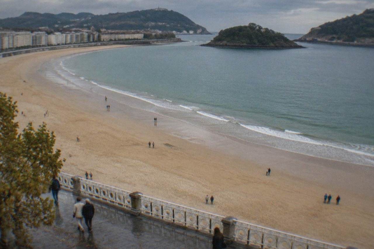 The curved sandy beach of La Concha in San Sebastián seen from above on a mild September day