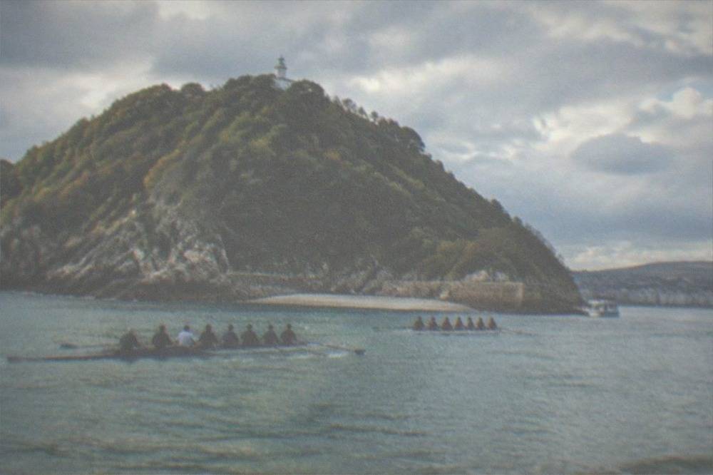 Traditional rowing teams training on La Concha bay in front of Santa Clara island
