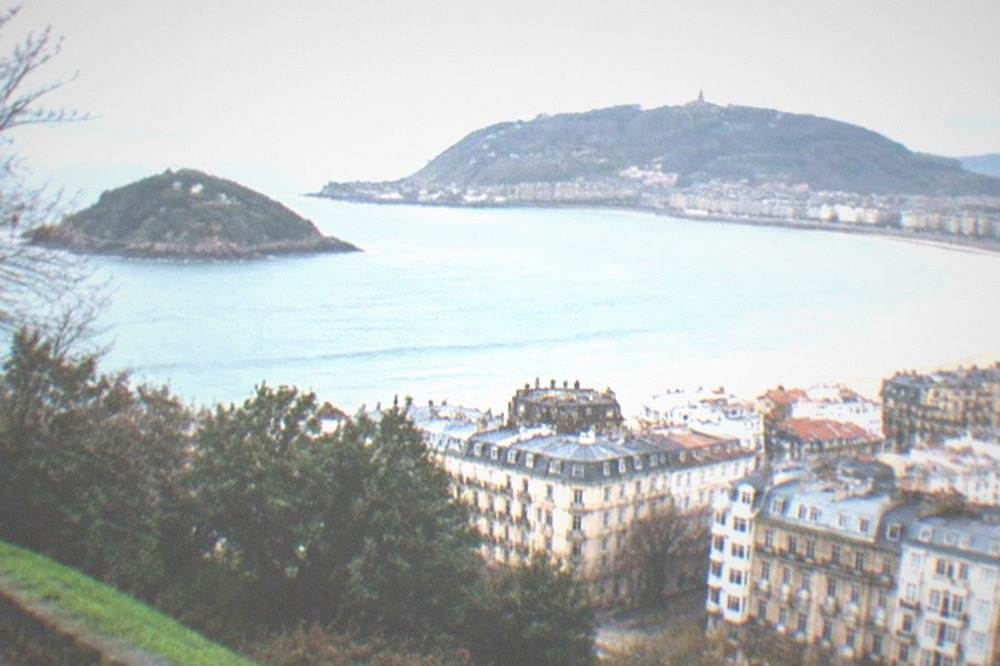 View from a green hilltop over the whole bay crescent and city rooftops