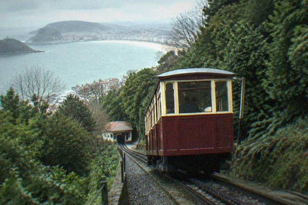 The wooden funicular car of Monte Igueldo on its rack track with the bay behind