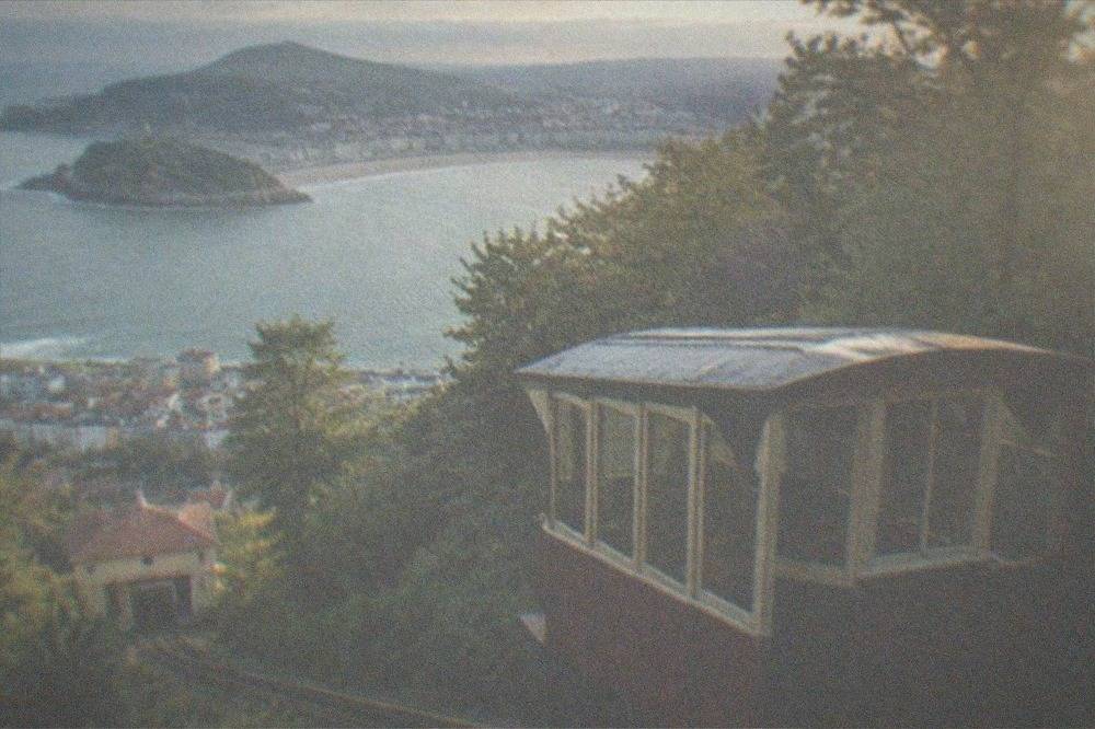 The wooden funicular car of Monte Igueldo climbing the hill above the city