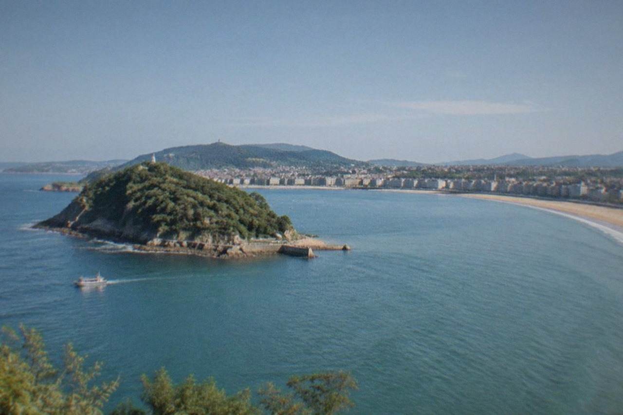 The sandy curve of La Concha beach in San Sebastián with Santa Clara island in the bay