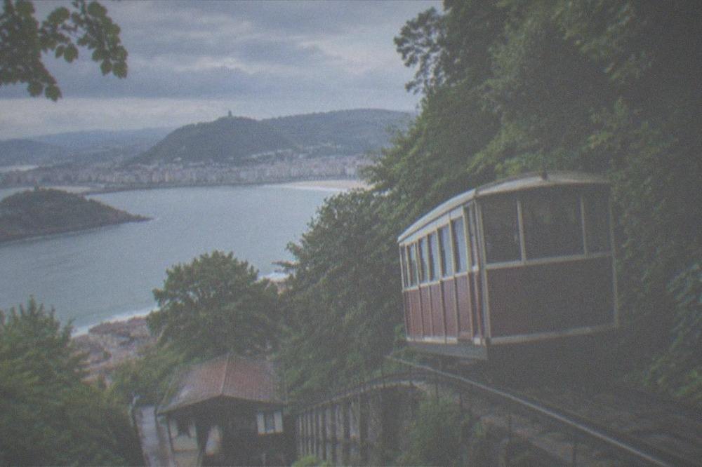 The wooden funicular car climbing the hillside toward Monte Igueldo