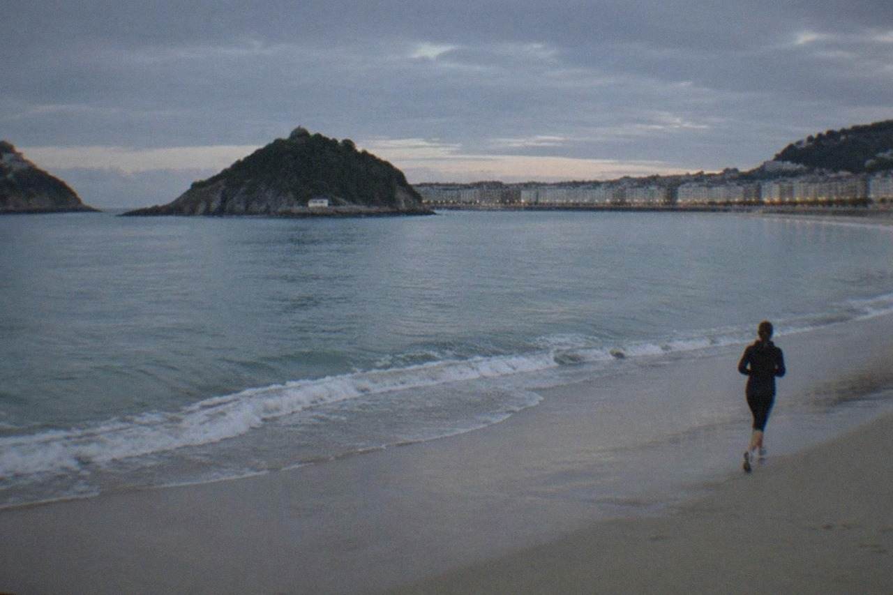 The curved sandy bay of La Concha in San Sebastián seen from above on a soft Atlantic morning